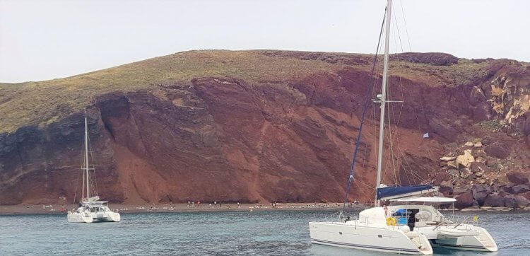 Red_beach of Akrotiri from the sea when sailing around Santorini, Greece